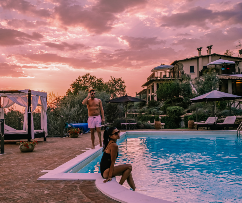 sugar couple enjoying their holiday time together in a pool during a sunset